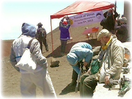 Author R.O. Blättner and co-author W.Kraußer-Blättner on Mauna Kea summit setting up observation tools, watched by Randa Marhenke